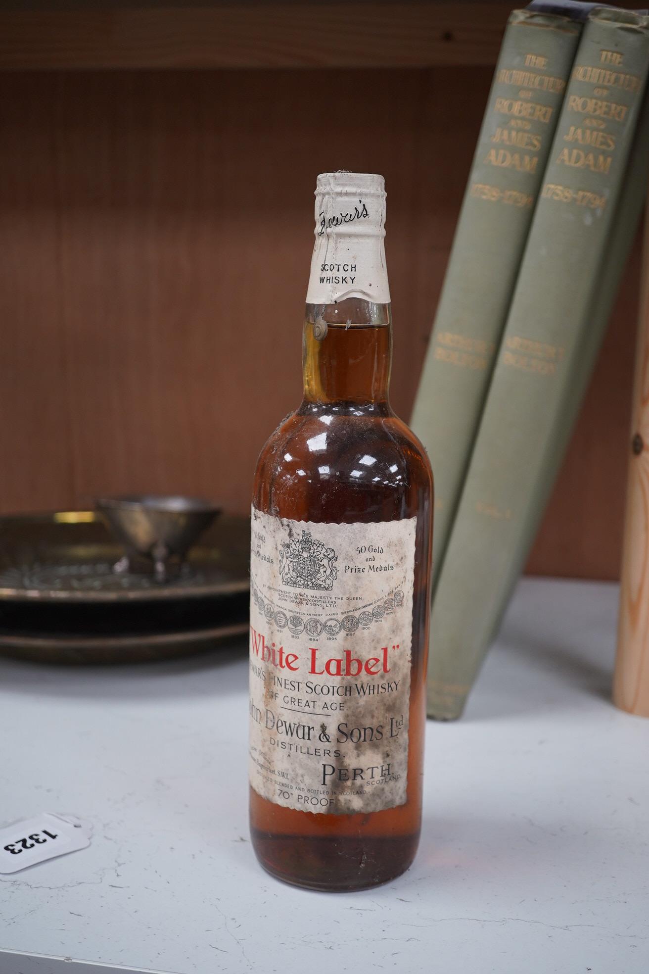 John Dewar & Sons Ltd. White Label, Finest Scotch Whisky Of Great Age, By Appointment to Her Majesty The Queen. Condition - label stained, bottle dirty, sealed